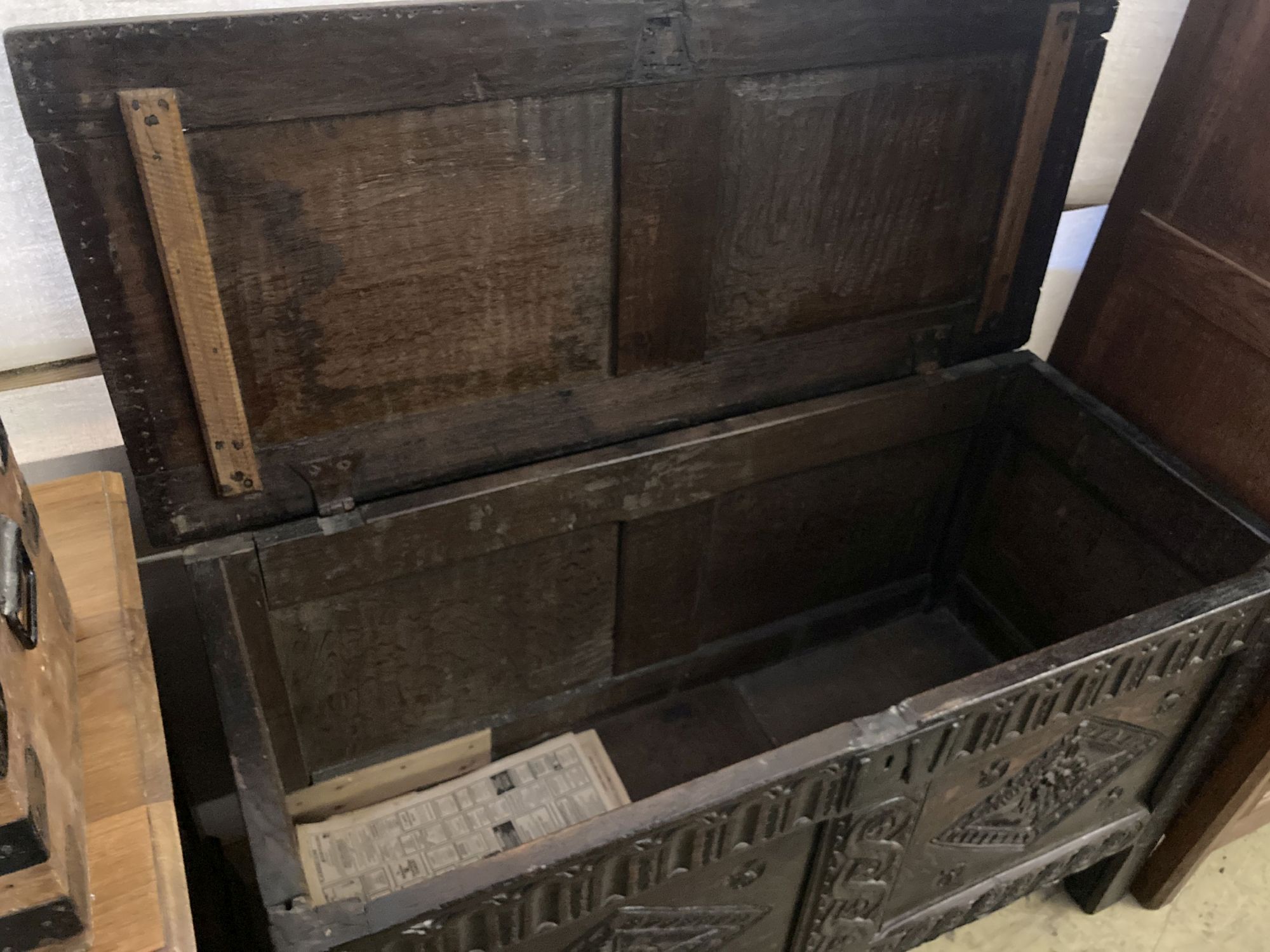 An 18th century carved oak coffer with twin panelled front, width 125cm, depth 55cm, height 75cm